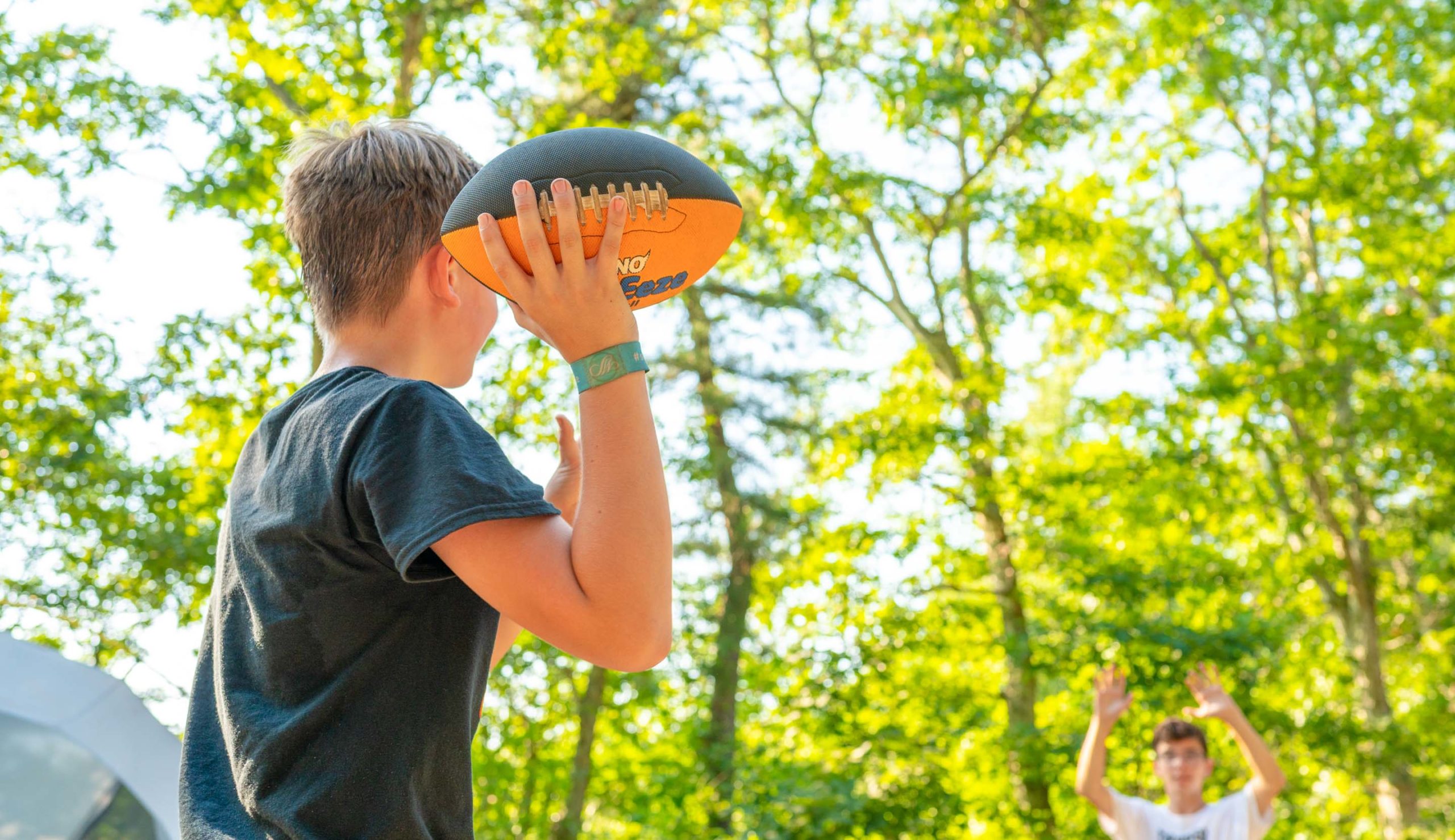 Camper throwing a football