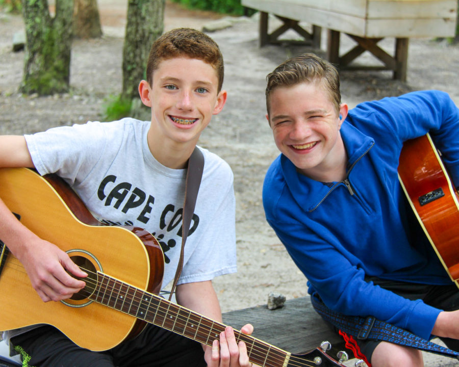 Two boys playing guitar