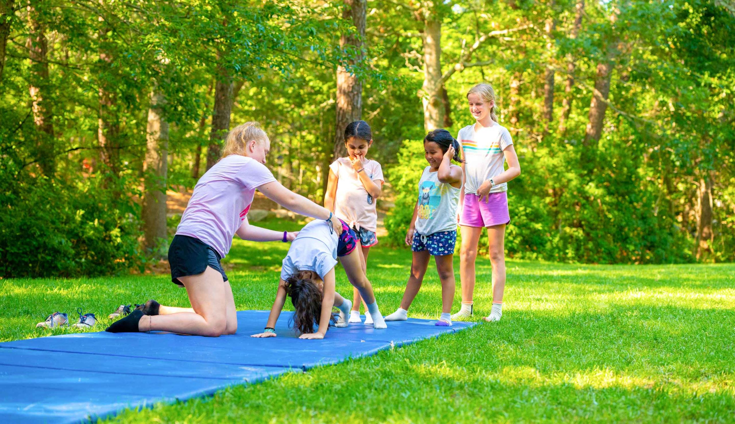 Young campers doing gymnastics outside