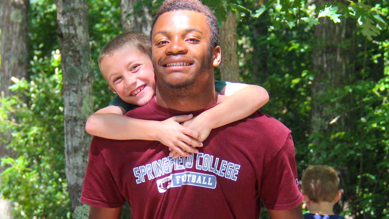 Child piggy backing on a counselor