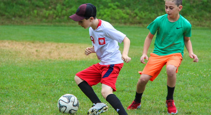 two boys playing soccer